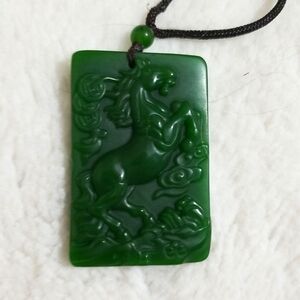 Jade color pendant, two inches long with a beautiful carved horse.